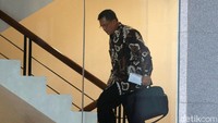 Dedeng nampak mengenakan kemeja batik lengan panjang saat menaiki tangga menuju ruang pemeriksaan di gedung KPK, Jakarta.