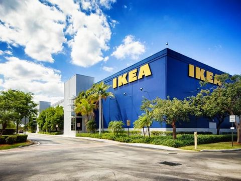 Corner view of the Ikea furniture store in Sunrise Florida near Fort Lauderdale on a mostly sunny Winter day. The image features the typical blue store with the yellow logo on its wall.