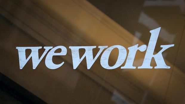 FILE PHOTO: The WeWork logo is displayed on the entrance of a co-working space in New York City, New York U.S., January 8, 2019. REUTERS/Brendan McDermid/File Photo
