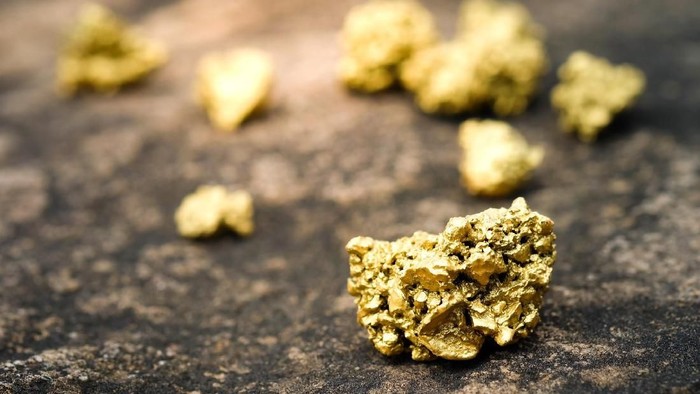 A lump of gold on a stone floor
