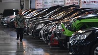 Seorang warga melintas diantara deretan mobil bekas yang dijual di Bursa Mobil bekas WTC Mangga Dua, Jakarta Utara, Jumat (17/5/2019).