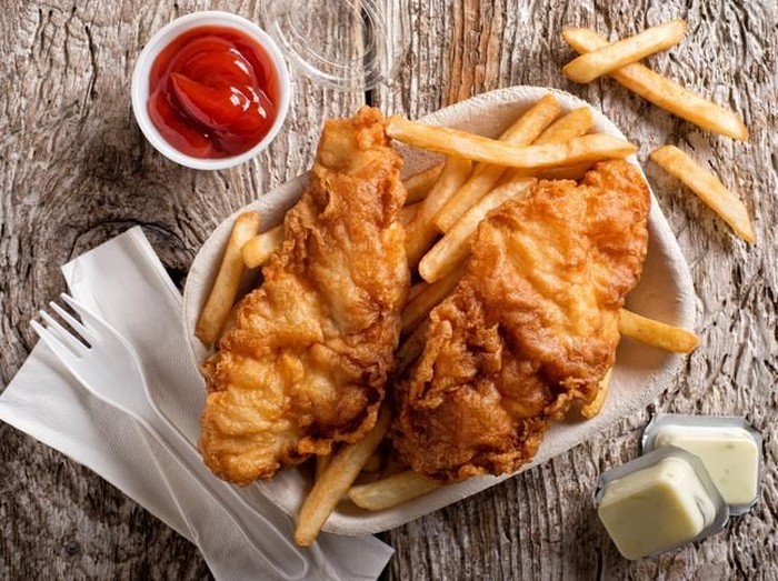 fish and chips Frying wiener schnitzel in a hot pan with cooking oil