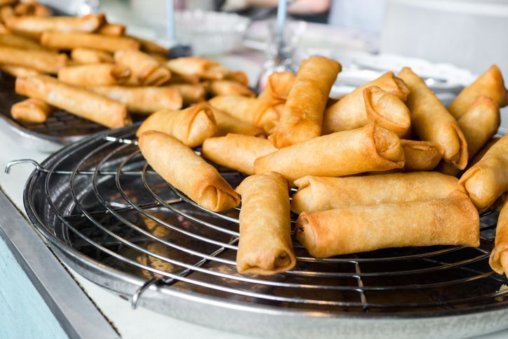 Deep fried spring rolls and vegetables on plate