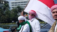 Salah seorang peserta aksi nampak membawa bendera merah putih saat akan menuju gedung Bawaslu.