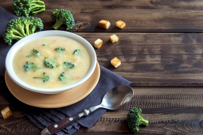 Vegetable and cheese cream soup with broccoli and croutons over wooden background with copy space - homemade healthy organic vegetarian vegan diet fresh food meal dish soup lunch