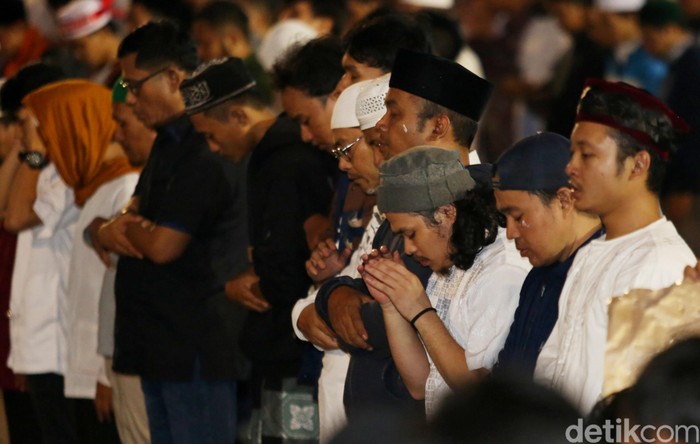 Massa di depan Bawaslu tampak menunaikan ibadah salat Maghrib. Mereka salat berjamaah usai berbuka.
