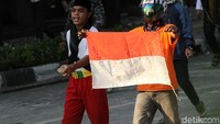 Sebagian dari mereka membentangkan bendera merah putih.