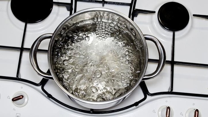 Water boiling in a clear glass pot.