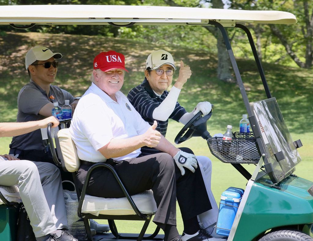 U.S. President Donald Trump sits on a cart as Japanese Prime Minister Shinzo Abe drives the cart as they play golf at Mobara Country Club in Mobara, Chiba prefecture, Japan, in this photo released by Japan's Cabinet Public Relations Office via Kyodo May 26, 2019.  Mandatory credit Japan's Cabinet Public Relations Office via Kyodo/via REUTERS ATTENTION EDITORS - THIS IMAGE WAS PROVIDED BY A THIRD PARTY. MANDATORY CREDIT. JAPAN OUT. NO COMMERCIAL OR EDITORIAL SALES IN JAPAN.