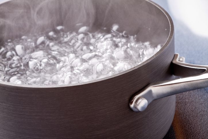 Water boiling in a clear glass pot.