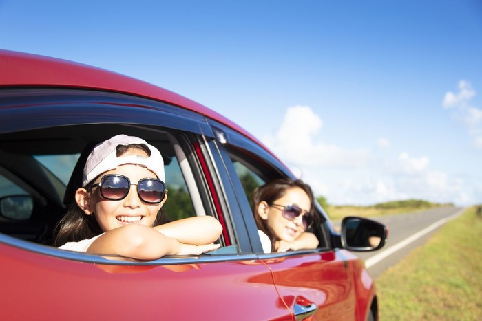 Happy mother and daughter enjoy road trip