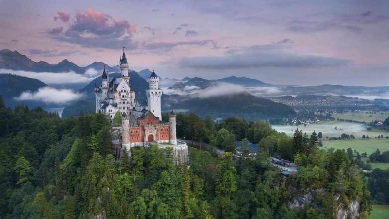 Kastil Disney di Dunia Nyata486403572 Hohenschwangau, Germany - August 10, 2015: view of Neuschwanstein Castle on august 10th near Hohenschwangau, Germany during foggy summer twilight.