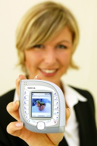 HANOVER, GERMANY - MARCH 18:  A model holds the new Nokia 7600 mobile phone at the CeBIT technology trade fair March 18, 2004 in Hanover, Germany. The 7600 is both UMTS and GMS standard capable. This year a total of 6,411 exhibitors are taking part in the seven-day fair.     (Photo Sean Gallup/Getty Images)