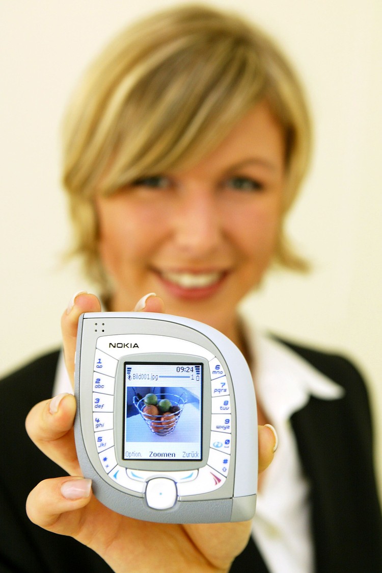 HANOVER, GERMANY - MARCH 18:  A model holds the new Nokia 7600 mobile phone at the CeBIT technology trade fair March 18, 2004 in Hanover, Germany. The 7600 is both UMTS and GMS standard capable. This year a total of 6,411 exhibitors are taking part in the seven-day fair.     (Photo Sean Gallup/Getty Images)