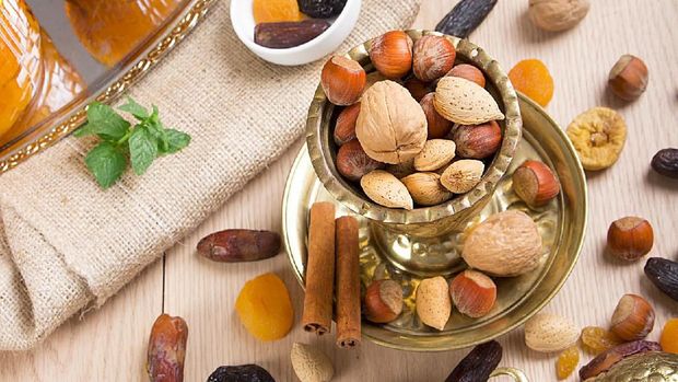 Ramadan Atmosphere - Collection of Ramadan Fruits and Nuts with Lantern on wooden table