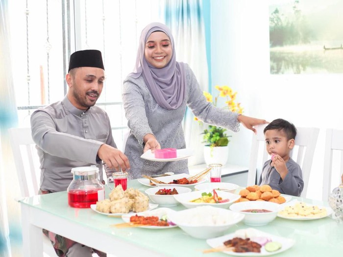 A Malay Muslim family having Hari Raya Aidlfitri/ Eid-Ul-Fitr meals at their home on in Malaysia.