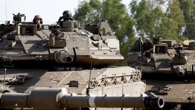 Israeli soldiers manoeuver Merkava tanks in the Israeli-annexed Golan Heights on June 2, 2019. (Photo by JALAA MAREY / AFP)