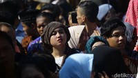 Ada juga warga yang melindungi kepalanya dari sinar matahari dengan menggunakan kain.