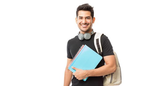 Portrait of smiling young college student with books and backpack against white background