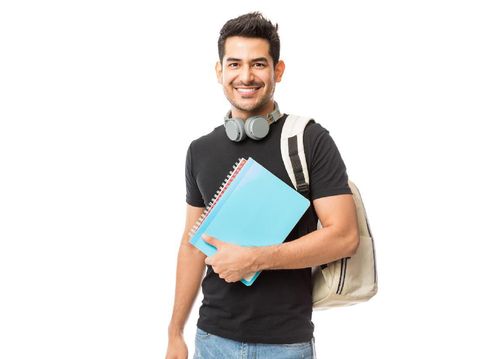 Portrait of smiling young college student with books and backpack against white background