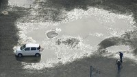 Sebuah mobil nampak tersangkut di area likuifaksi akibat gempa yang mengguncang wilayah Tsuruoka, Prefektur Yamagata, Rabu (19/6/2019).