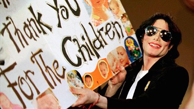 FILE PHOTO: Michael Jackson displays a poster he received from fans during an appearance on 