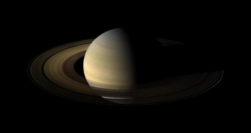 This NASA handout image obtained October 19, 2009 shows Saturn during an equinox captured by the robot explorer Cassini. The images comprising the mosaic, taken over about eight hours, were extensively processed before being joined together. With no enhancement, the rings would be essentially invisible in this mosaic. To improve their visibility, the dark right half of the rings has been brightened relative to the brighter left half by a factor of three, and then the whole ring system has been brightened by a factor of 20 relative to the planet. So the dark half of the rings is 60 times brighter, and the bright half 20 times brighter, than they would have appeared if the entire system, planet included, could have been captured in a single image.The images were taken on August 12, 2009, beginning about 1.25 days after exact equinox, using the red, green and blue spectral filters of the wide angle camera and were combined to create this natural color view. The images were obtained at a distance of approximately 526,000 miles from Saturn and at a Sun-Saturn-spacecraft, or phase, angle of 74 degrees. Image scale is 31 miles per pixel. AFP PHOTO/NASA/JPL/SPACE/RESTRICTED TO EDITORIAL USE (Photo by HO / NASA / AFP)