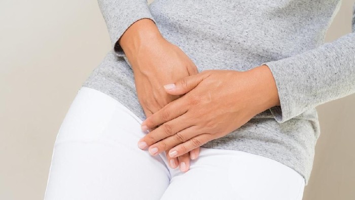 Woman with Hands Holding her Crotch