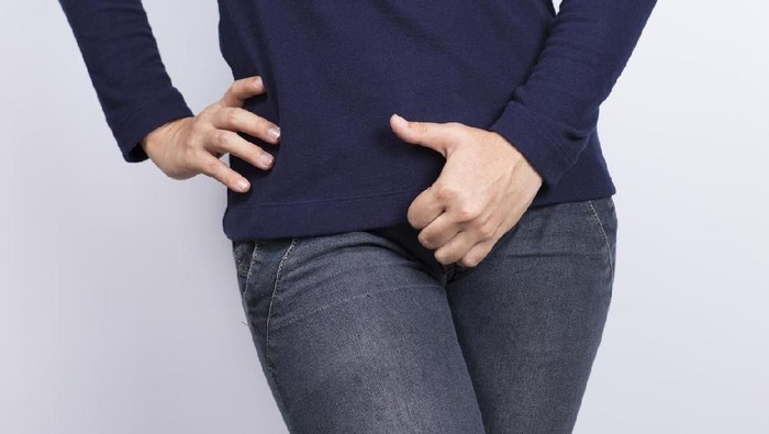 Ilustrasi Miss V Woman with Hands Holding her Crotch
