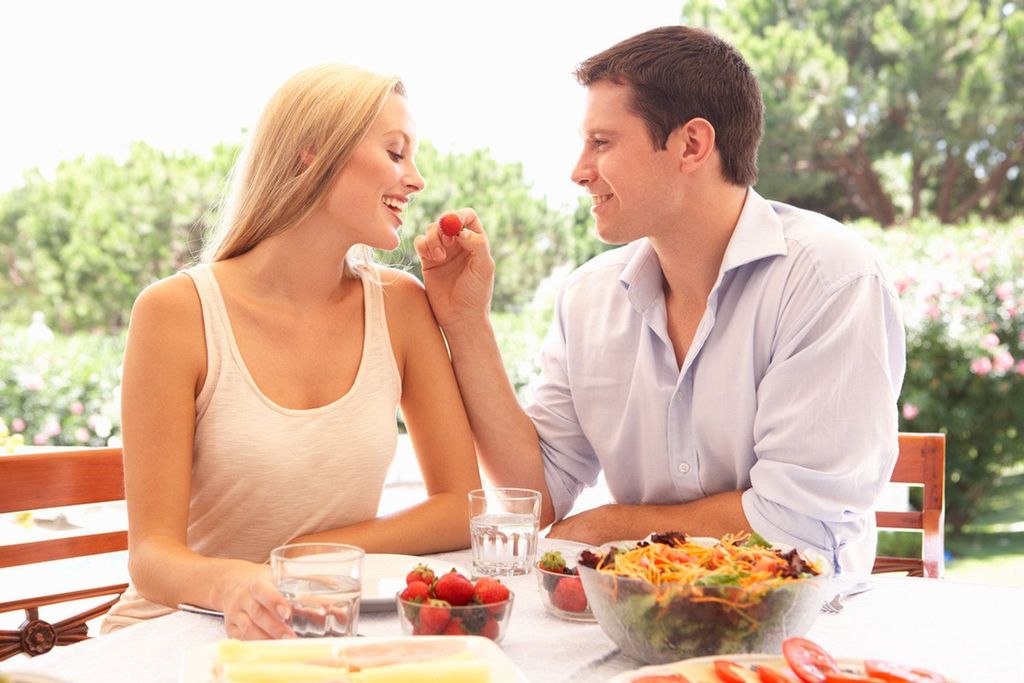 Happy loving couple enjoying breakfast in a cafe. Love, dating, food, lifestyle