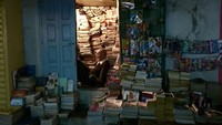 Potret seorang penjaga toko buku di Maroko yang mengisi waktu saat menunggu pelanggan dengan membaca buku. Istimewa/Dok. Boredpanda/Agora Photo/@travelmomentcaptures.