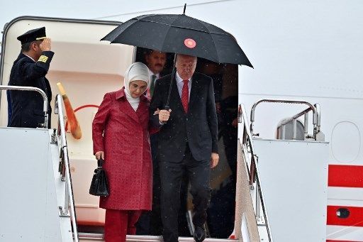 Turkish President Recep Tayyip Erdogan and his wife Emine Erdogan arrive at Kansai airport in Izumisano city, Osaka prefecture, on June 27, 2019 ahead of the G20 Osaka Summit. (Photo by CHARLY TRIBALLEAU / AFP)