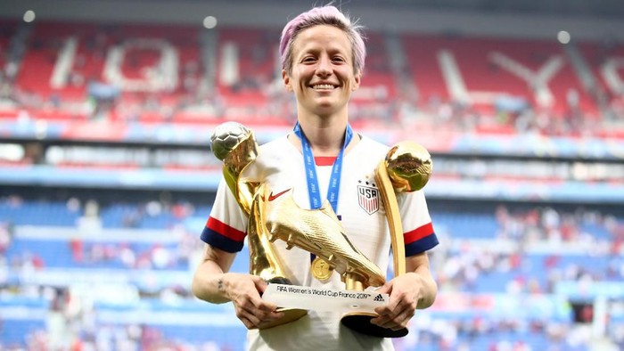 LYON, FRANCE - JULY 07:  Megan Rapinoe of the USA celebrates with the FIFA Womens World Cup Trophy, the Golden Boot and The Golden Ball following the 2019 FIFA Womens World Cup France Final match between The United States of America and The Netherlands at Stade de Lyon on July 07, 2019 in Lyon, France. (Photo by Alex Grimm/Getty Images)