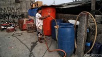 Seorang warga menampung air bersih di sejumlah tempat penampungan di rumahnya di kawasan Muara Baru, Jakarta Utara.