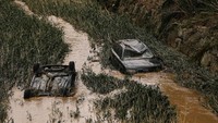 Dua buah mobil nampak rusak cukup berat usai diterjang banjir yang terjadi di Kota Tafalla, Navarra, Spanyol, pada Selasa (9/7/2019) waktu setempat. Susana Vera/Reuters.