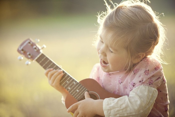 Little girl playing guitar