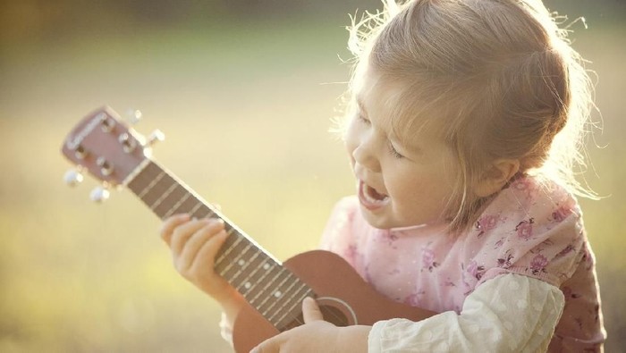 Little girl playing guitar