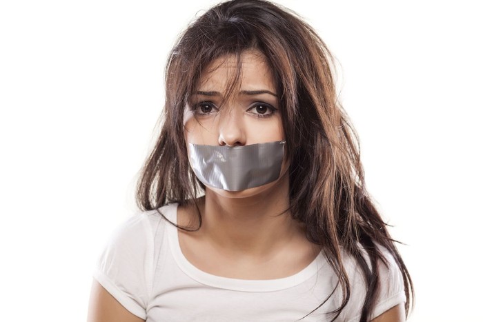 sad girl with self-adhesive tape over her mouth