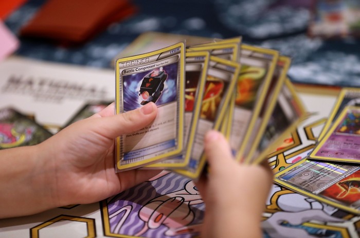 SAN FRANCISCO, CA - AUGUST 19:  A contestant looks at cards as he competes during the 2016 Pokemon World Championships on August 19, 2016 in San Francisco, California. Over 1,600 contestants from more than 30 countries are competing in tournaments of the Pokemon video game, Pokken and Trading Card Game events during the 2016 Pokemon World Championships. $500,000 in scholarships and prizes will be awarded to winners.  (Photo by Justin Sullivan/Getty Images)