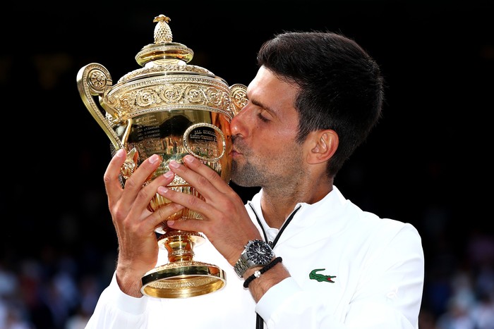 LONDON, ENGLAND - JULY 14:  Novak Djokovic of Serbia kisses the trophy after winning his Mens Singles final against Roger Federer of Switzerland during Day thirteen of The Championships - Wimbledon 2019 at All England Lawn Tennis and Croquet Club on July 14, 2019 in London, England. (Photo by Clive Brunskill/Getty Images)