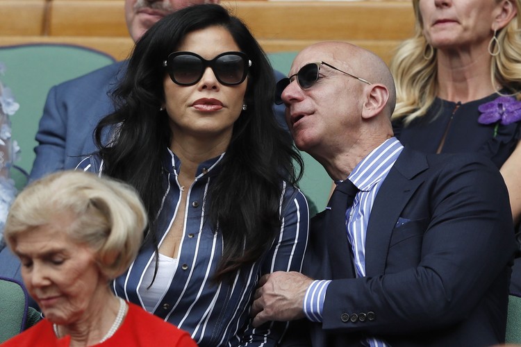 Jeff Bezos Amazon Founder and CEO Jeff Bezos, right, and Lauren Sanchez, watch Serbias Novak Djokovic play Switzerlands Roger Federer during the mens singles final match of the Wimbledon Tennis Championships in London, Sunday, July 14, 2019. (Adrian Dennis/Pool Photo via AP)