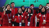 Sejumlah penonton kompak mengenakan baju warna merah. Mereka juga memakai ikat kepala merah putih.