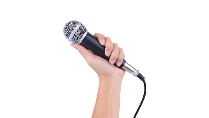 hand with a microphone isolated on white background