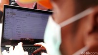 Petugas menginput data hasil uji emisi kendaraan.