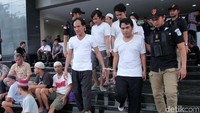 Para tersangka dibawa ke Kejaksaan Tinggi DKI Jakarta dengan pengawalan polisi.