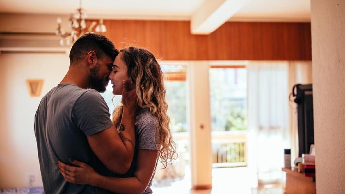 Loving young hipster couple relaxing at home and kissing