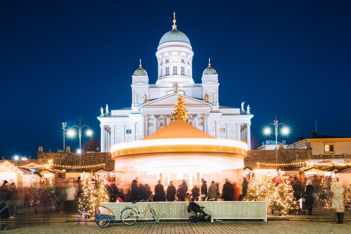 Helsinki, Finland. Xmas Christmas Market On Senate Square With Holiday Carousel And Famous Landmark Is Lutheran Cathedral In Winter Night.