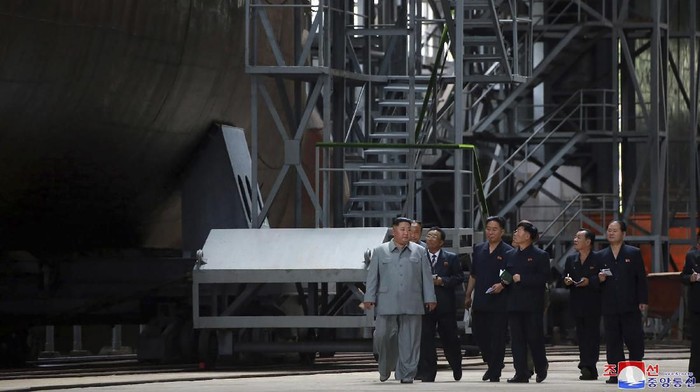 In this undated photo provided on Tuesday, July 23, 2019, by the North Korean government, North Korean leader Kim Jong Un, left, inspects a newly built submarine to be deployed soon, at an unknown location in North Korea. North Korean state medias report on Tuesday comes days after North Korea said it may lift its 20-month suspension of nuclear and missile tests to protest expected military drills between the United States and South Korea. Independent journalists were not given access to cover the event depicted in this image distributed by the North Korean government. The content of this image is as provided and cannot be independently verified. Korean language watermark on image as provided by source reads: 