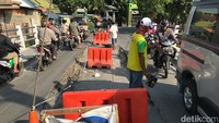 Tepat di titik amblas, telah dipasang kerucut dan pembatas jalan berwarna oranye (plastic road barrier). Pengguna jalan terpantau berhati-hati melintasi titik sekitar amblas. (Rolando/detikcom)