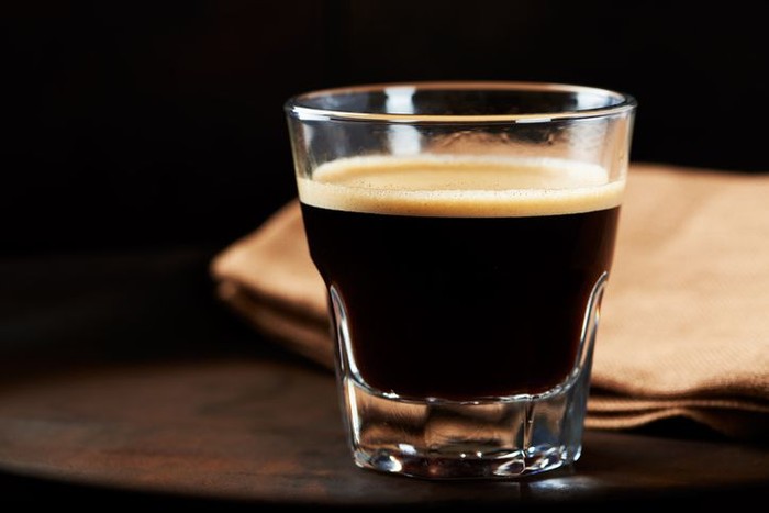 Glass of Espresso on dark background.